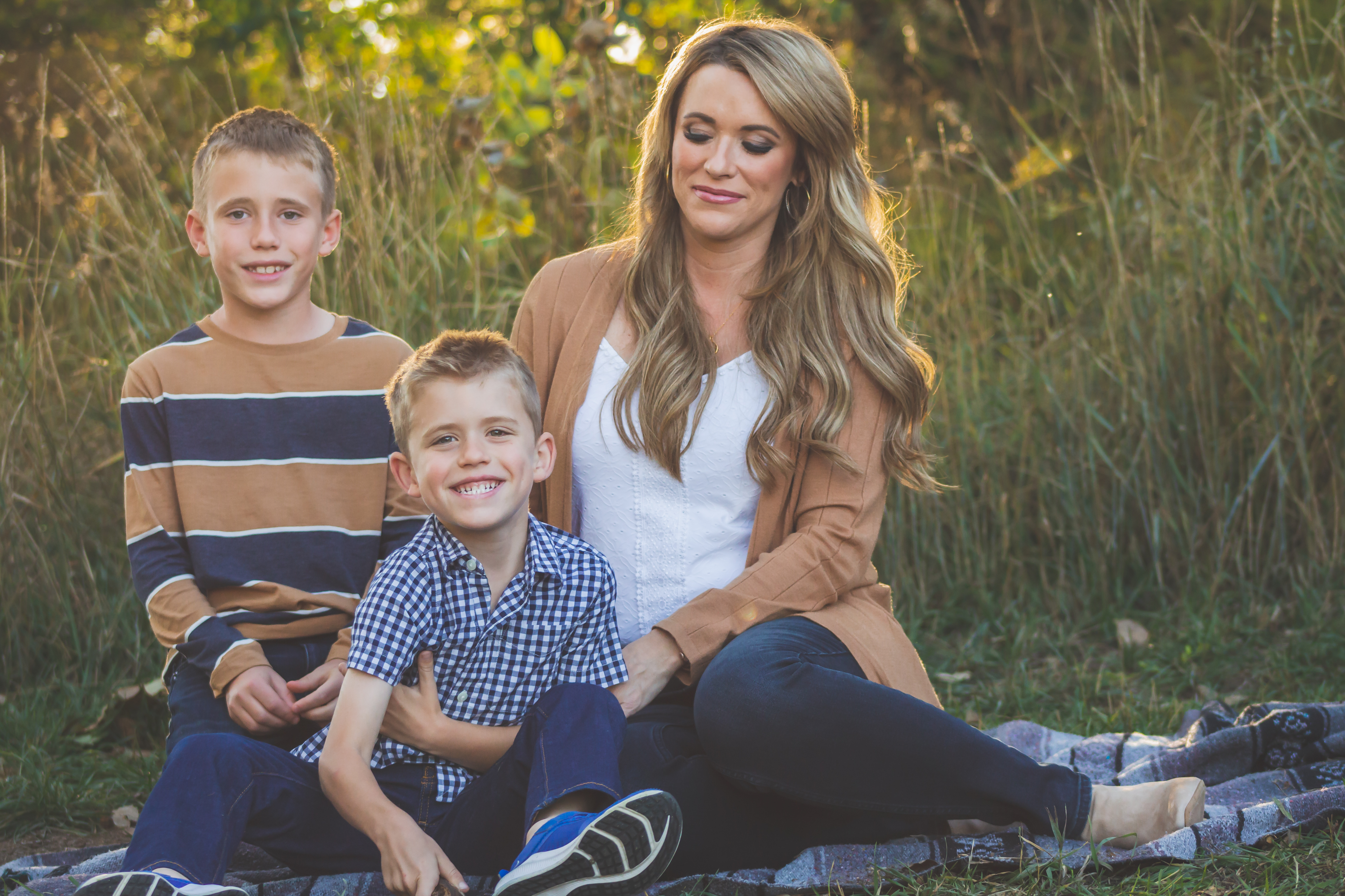mom tickles her boys in a family photo session