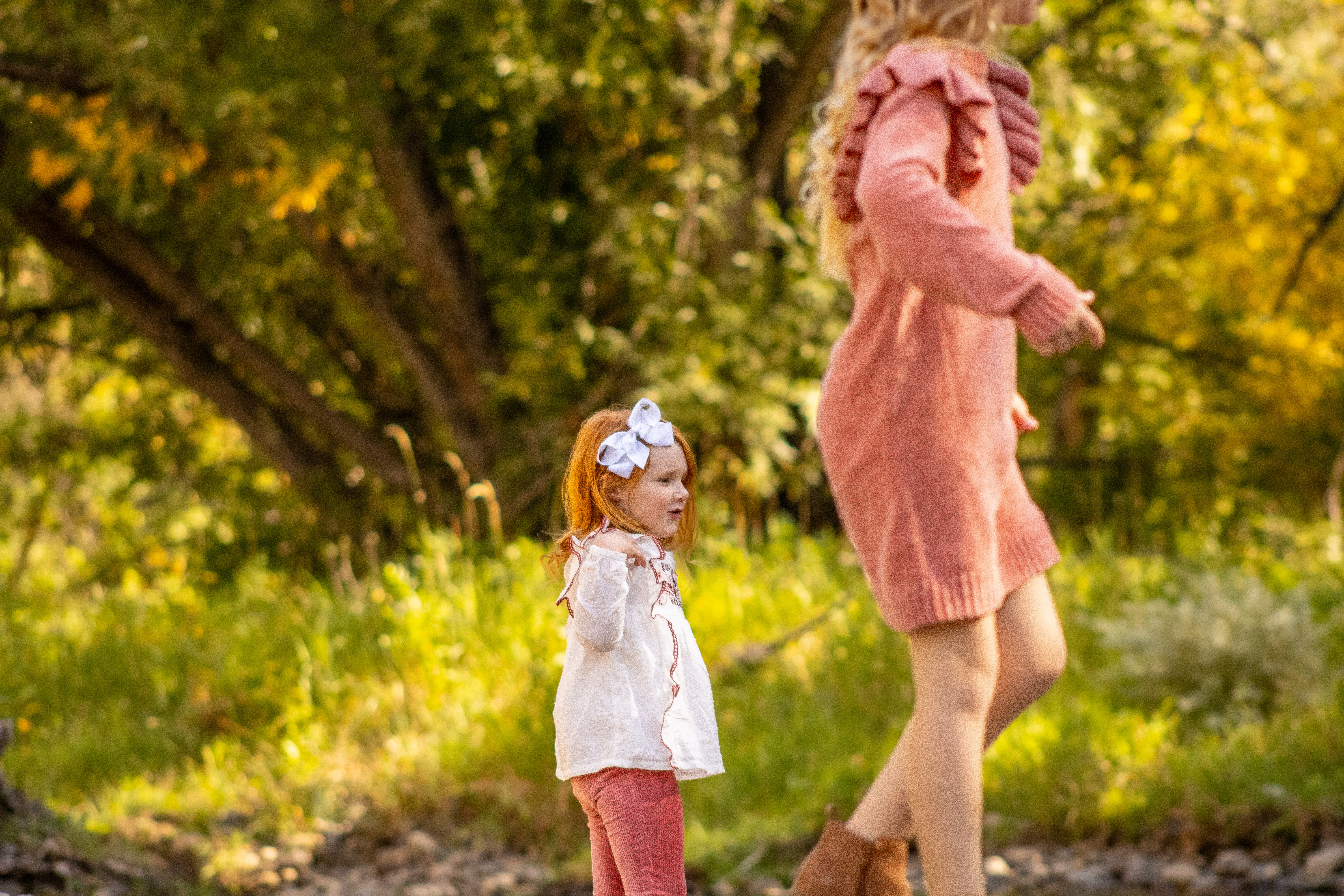 Two little girls play during a photo session